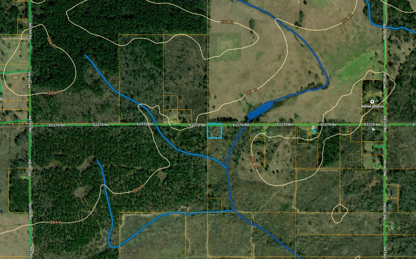County parcel map showing the tract outlined with surrounding parcels, contours and creeks.